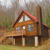 Photo of a cabin in the woods.